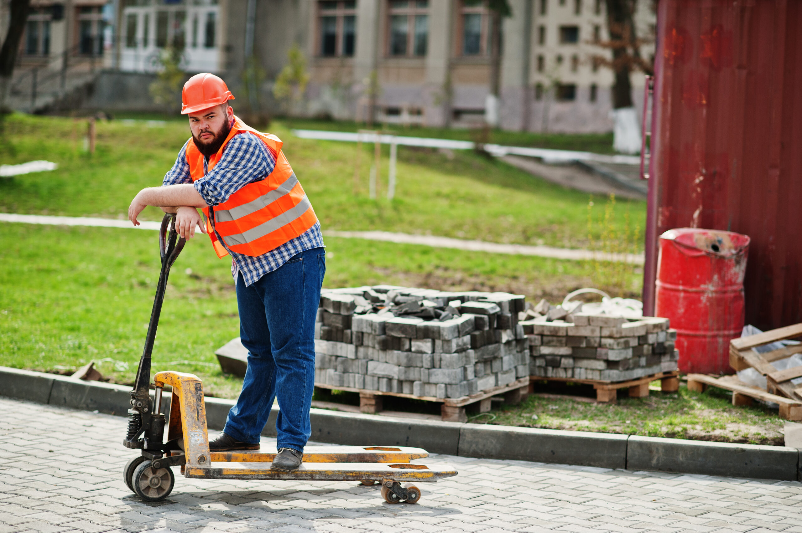 Brutal beard worker man suit construction worker in safety orang